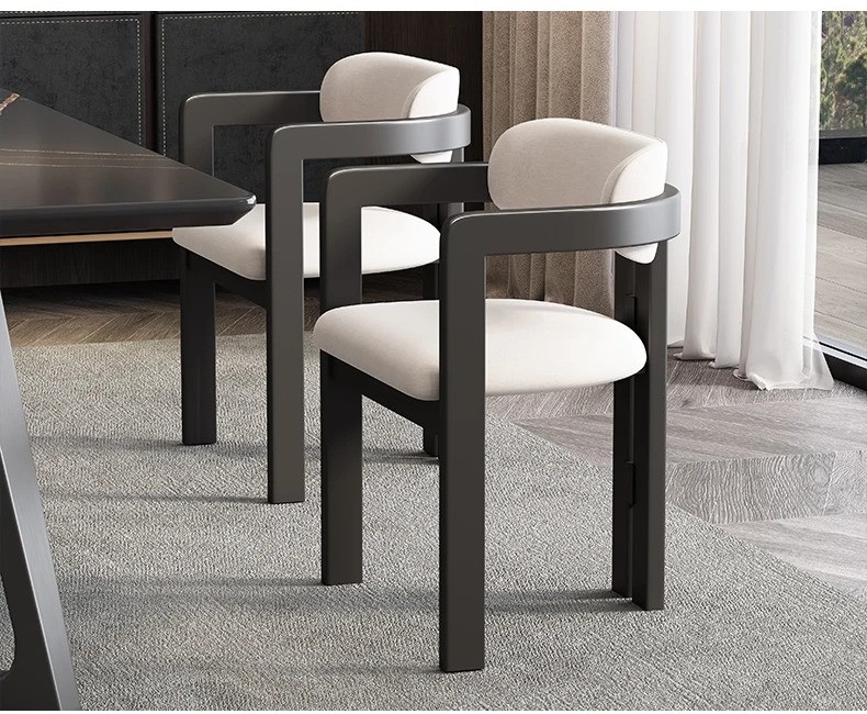 Contemporary solid Ash wood dining chair with curved backrest, black wooden frame, genuine Off-white leather upholstery, comfortable armrests, and modern luxury dining room design. All Black option available.