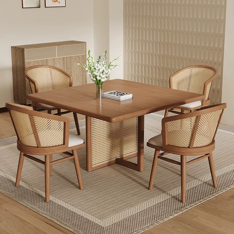 Solid pine wood square dining table with natural handwoven rattan cane back chairs in Japanese style, modern minimalist dining set for home, café, or restaurant interior.