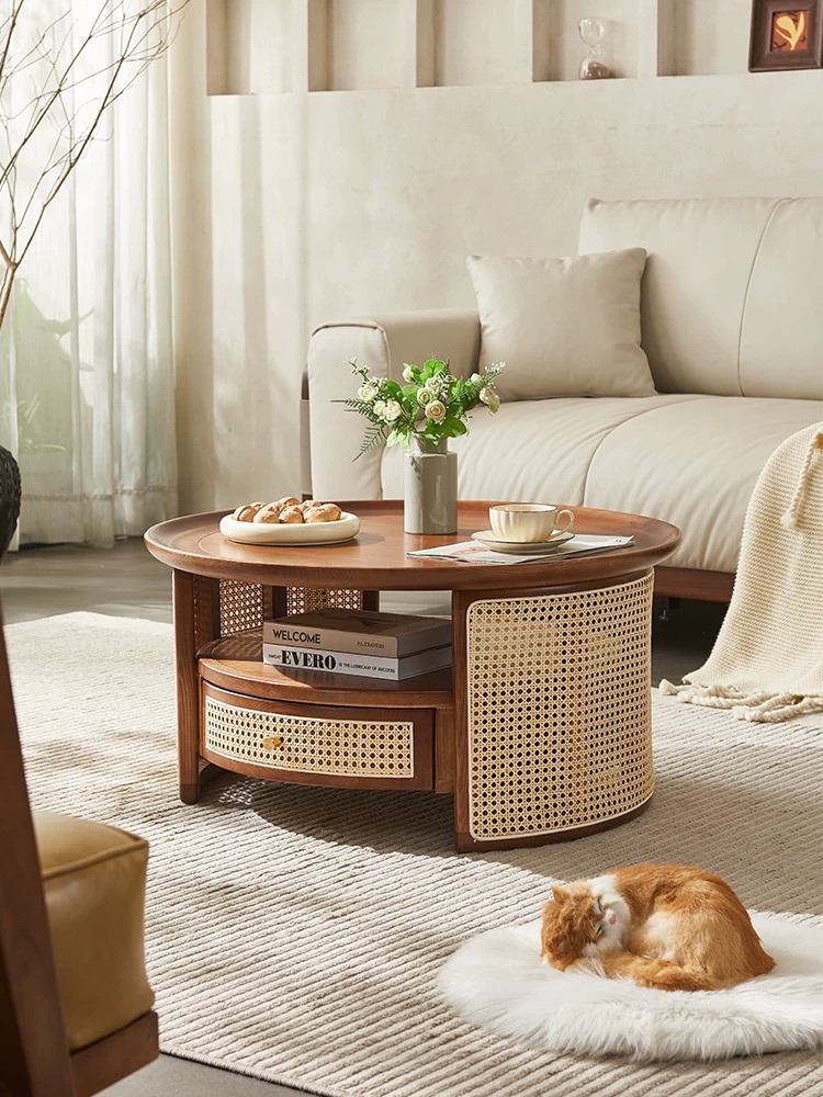 Round designer coffee table made of premium solid wood and natural rattan, featuring a smooth finish, drawer, and shelf storage, perfect for modern and Contemporary interiors.