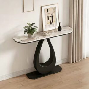Aesthetic console table with a Pandora sintered stone top and a matte black teardrop pedestal iron base, styled as an apartment entryway table with a potted plant.