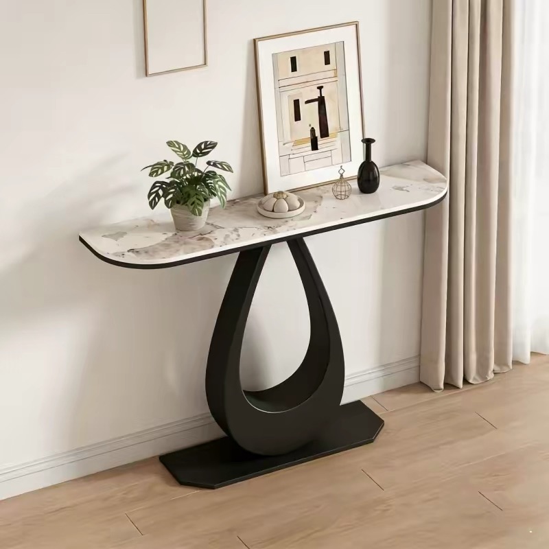 Aesthetic console table with a Pandora sintered stone top and a matte black teardrop pedestal iron base, styled as an apartment entryway table with a potted plant.