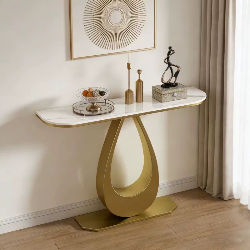 Modern luxury gold frame console table featuring a slim white sintered stone top with rounded edges, styled as a decorative foyer entry table with gold accents.