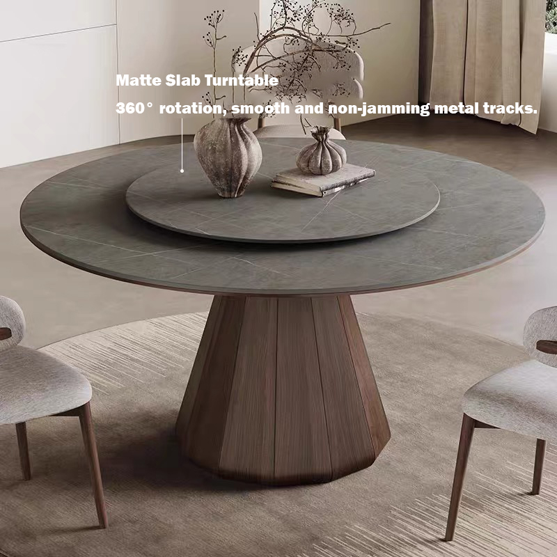 Modern round sintered stone dining table with a dark matte gray finish top and a detachable 360-degree rotating Lazy Susan turntable, supported by a fluted solid oak wood pedestal base, styled with contemporary upholstered dining chairs.