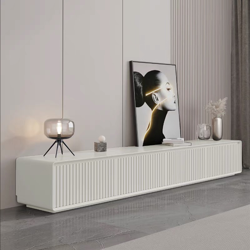 Gallery view of the contemporary fluted television unit in premium white color, showcasing its seamless wire-routing countertop and elegant three-dimensional vertical grille panels.