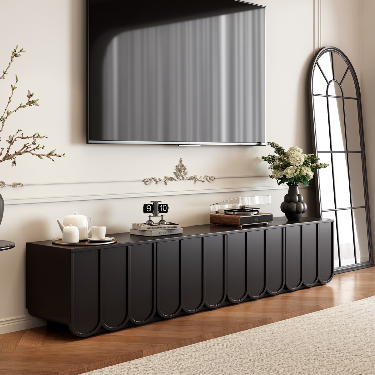 Black low-profile Japandi entertainment center with scalloped fluted solid wood doors and drawers.