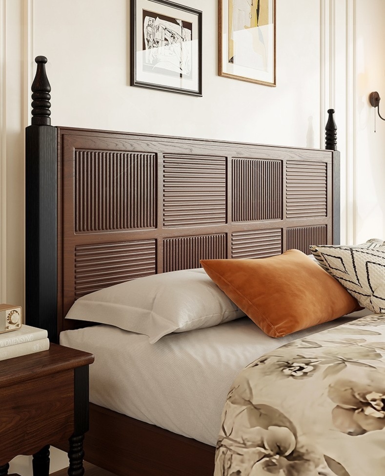 Close-up of dark wood king bed headboard featuring a handcrafted geometric mosaic panel pattern, hand-turned corner posts, and matching bedside table.