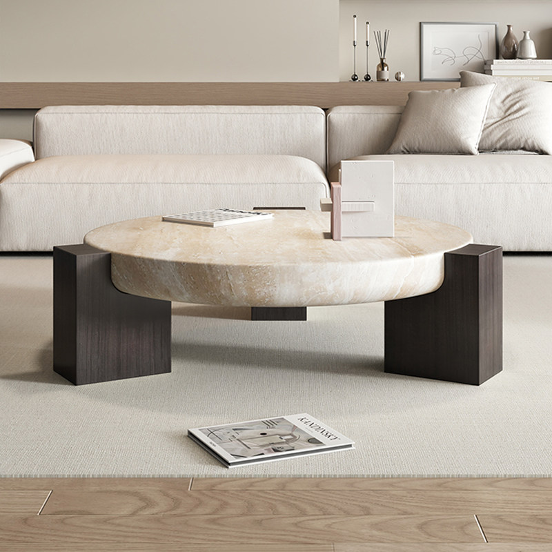 Natural beige marble round coffee table with black ash wood frame in a modern living room