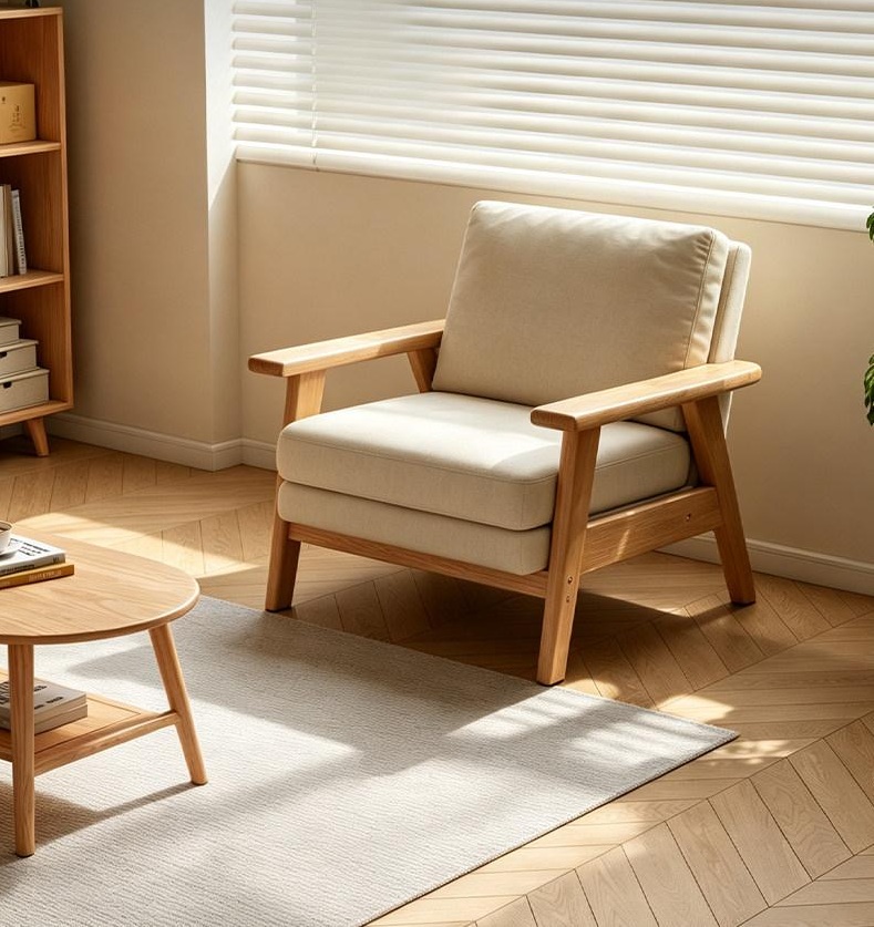 Solid wood accent armchair with off-white cotton linen cushion and natural rubberwood frame in a sunlit living room.